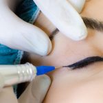 A trainee carrying out the eyeliner tattoo procedure at Cosmetic Tattoo Clinic.