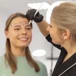 During one of the clinic's SPMU Cosmetic courses, a female student is practicing microblading treatment on a model.