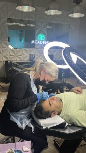 A cosmetic makeup artist carrying out Microblading on a male client.