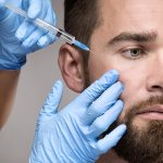 Bearded man using Gender-Inclusive SPMU Services and having an anti-wrinkle injection.